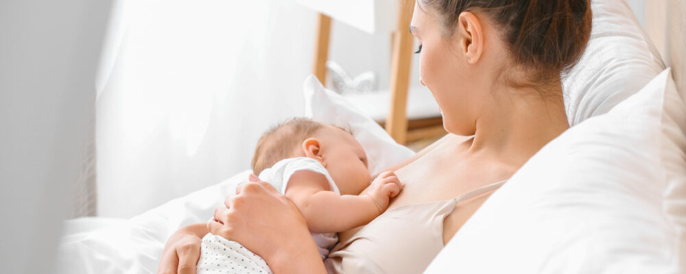 Young,Woman,Breastfeeding,Her,Baby,At,Home